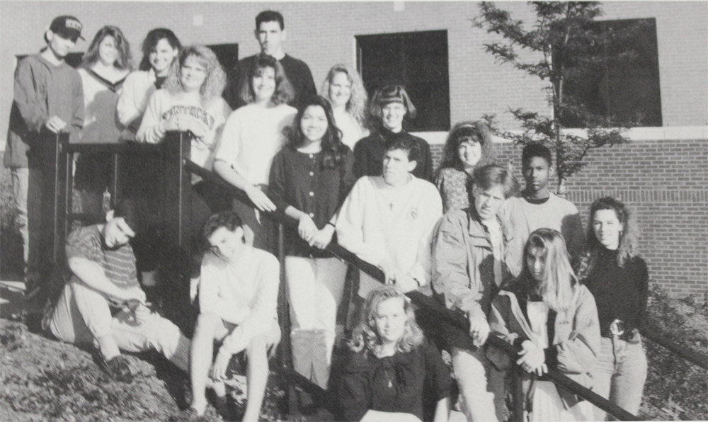 The original Lamplighter Staff posing in front of the school in 1990.