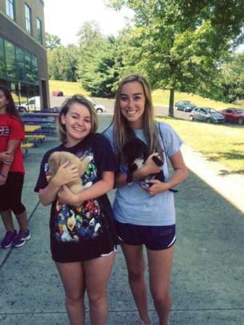 Pam Straits and I pose with puppies while volunteering at Dunbar's memorial garden.