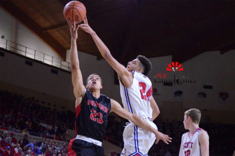 Senior Darius Williams grabs the rebound over Scott County