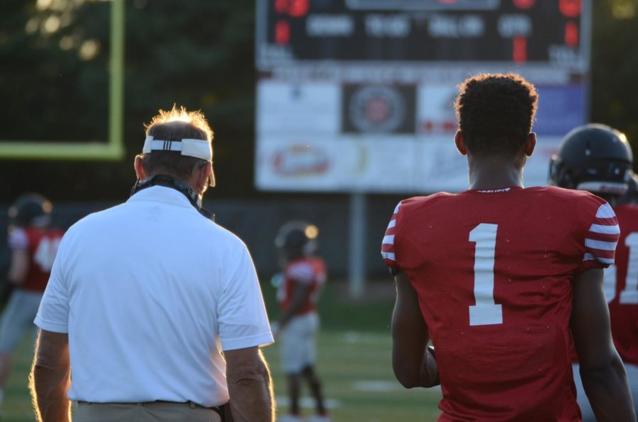 Coach Jim Franklin (left) and Tre Homer (right) watch on as the bulldogs get ready for kickoff 