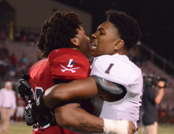Dunbar’s number 1, Tre Homer pushes a Lafayette player out of the fight and tries to calm him down. 
