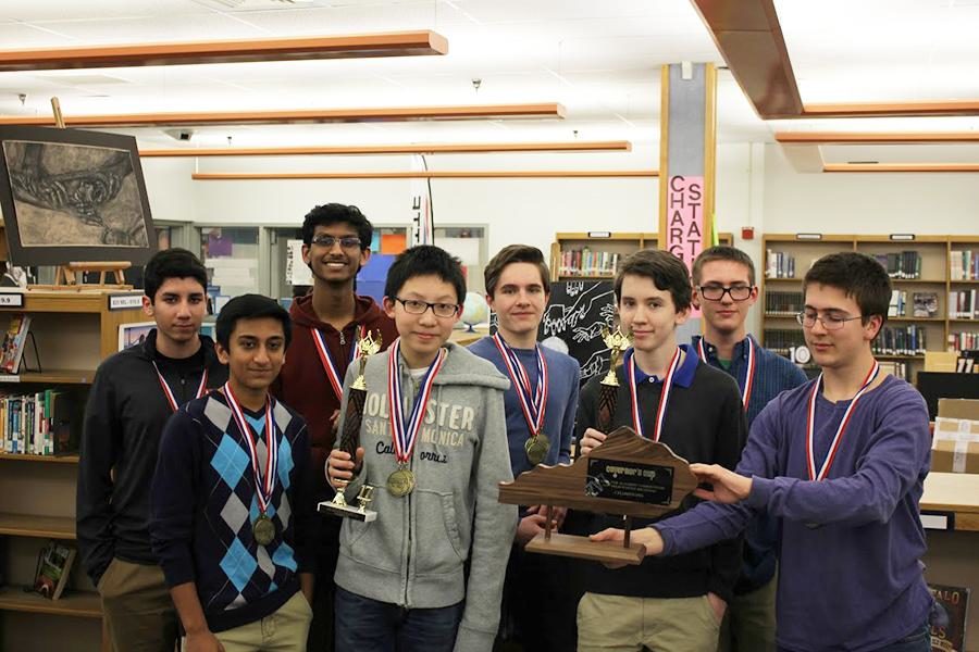 The boys academic team poses for a photo with their newly earned Governors Cup trophy.