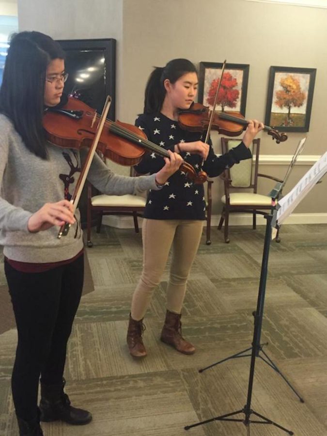 Sophomores Megan Guan and Stephanie Yang perform a violin-viola duet for the senior citizens.