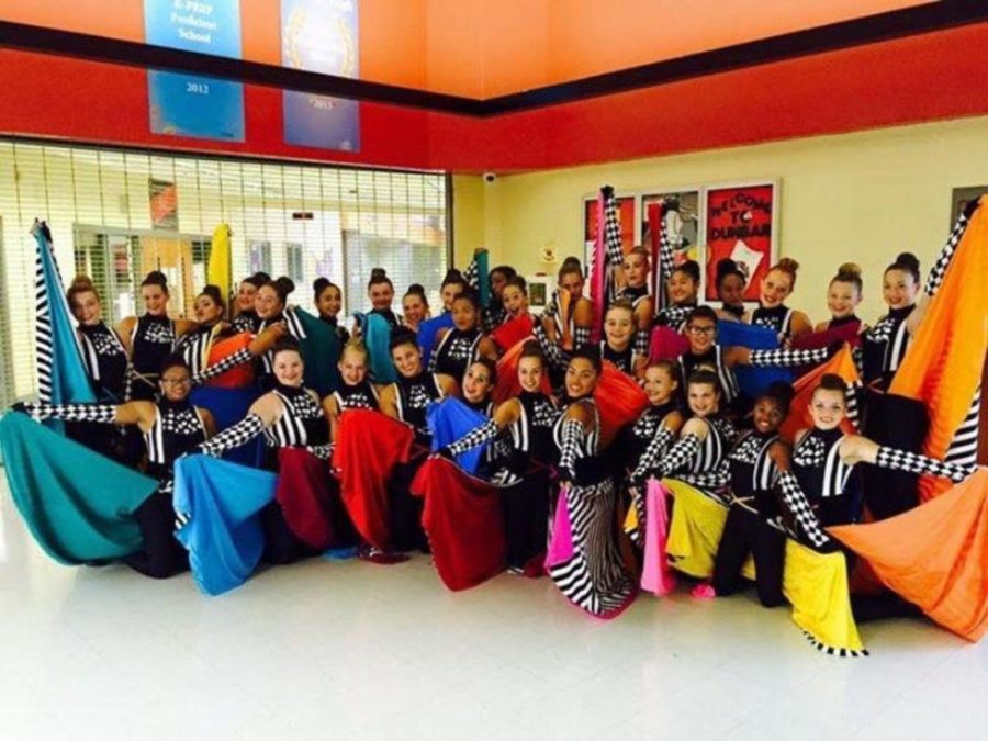 The color guard poses for a photo in their facade costumes.
