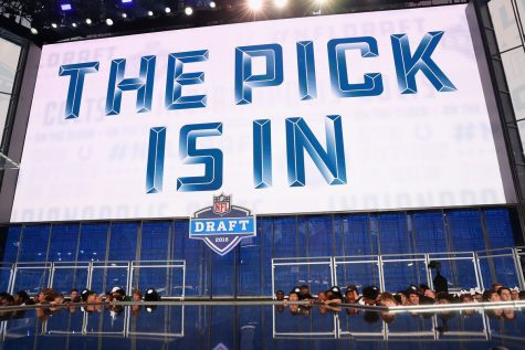 The stage from the 2018 NFL Draft. The screen is announcing that the next teams pick has come in from the front office. 