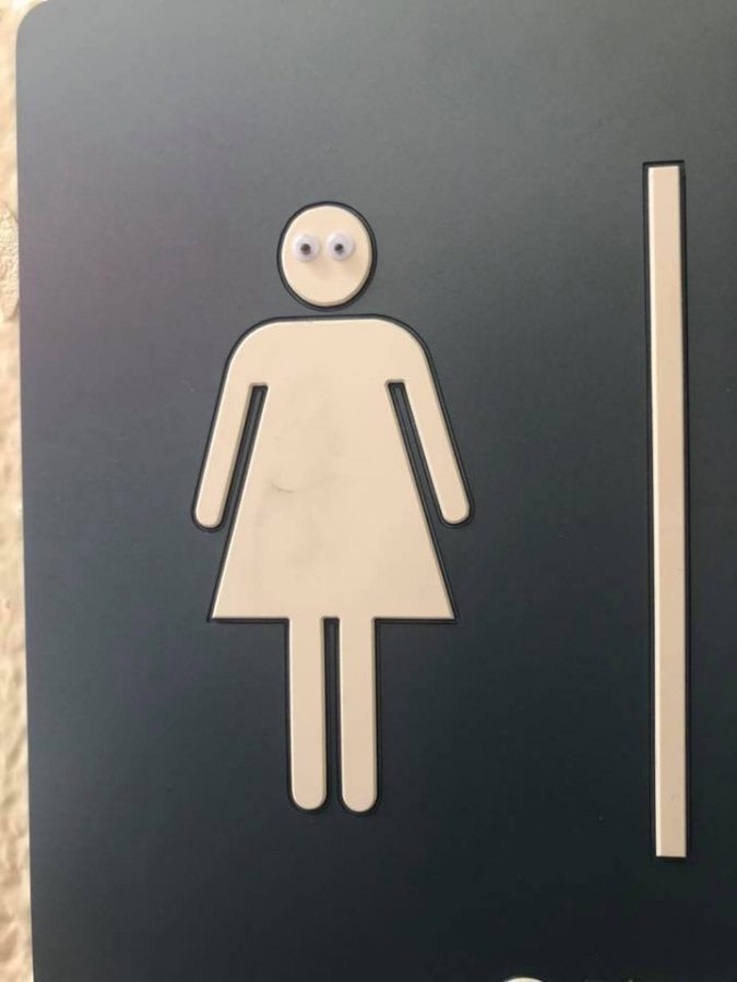 A bathroom sign became a little more lively with the addition of eyes.