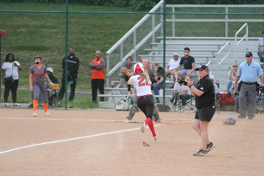 #22 Erica Vain rushes from third to home to try and get a run for Dunbar.