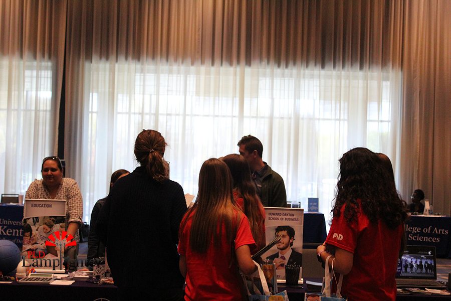 PLD students talk to a college booth about a education career.