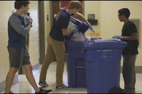 The recycling club going around and emptying bins after school. 