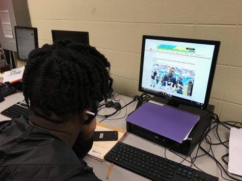 Student reading an online sports article. 