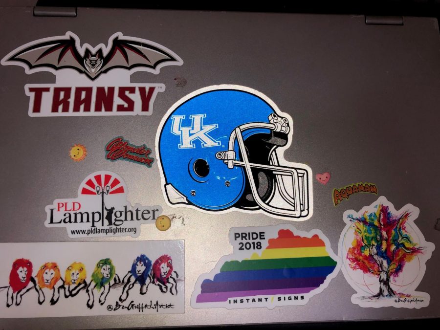 A laptop covered in stickers from various brands and events