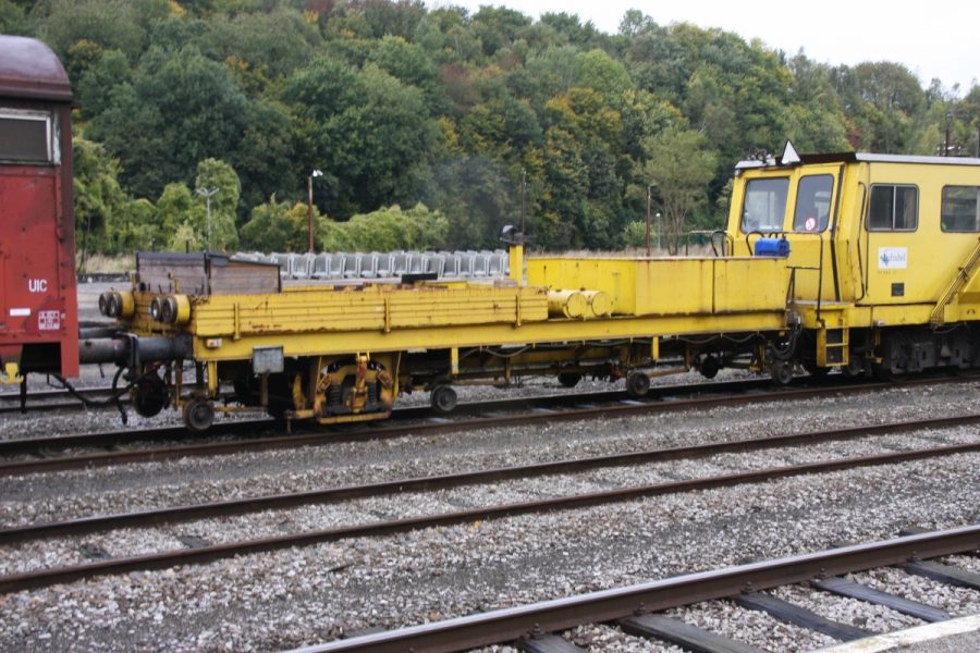 A railroad with a train cart on top of it.