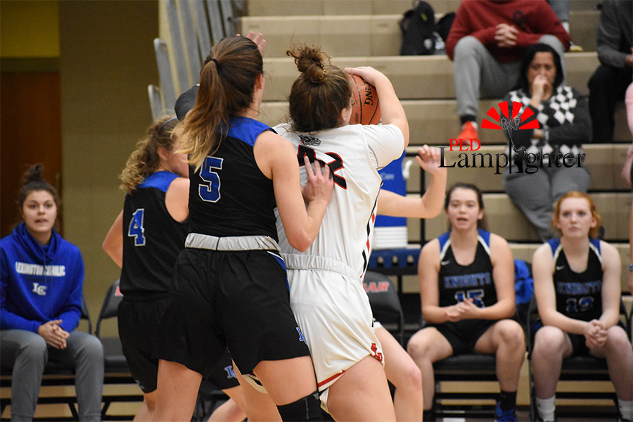 Haley Gadd, #42, goes up for the rebound to get the ball from Lexington Catholic. 