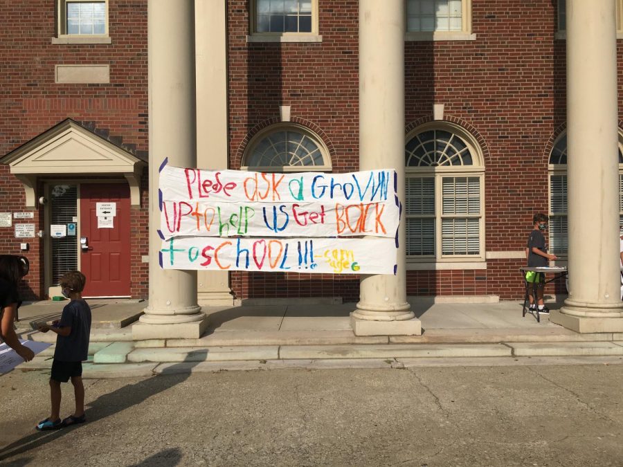 Protesters taped a handmade banner outside the FCPS building on Main Street.