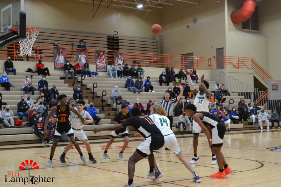 After Frederick Douglas committed a foul, Lionel Kumwimba makes a free throw for Dunbar.