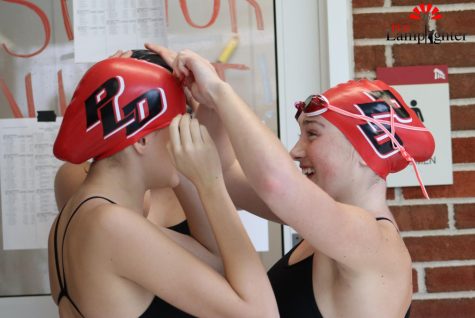 Freshmen Mallory Jones and Piper Stotz prepare to swim their 200 freestyle relay.