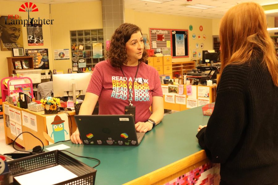 Ms. Perry does a lot of work around the library, but a big part of her day is helping students with tech problems.