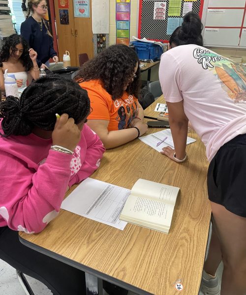 Senior Sukriti Kapoor assists Calleigh Snead and Daleigha Young in their freshman English class. The peer tutoring program at Dunbar allows peer to peer interaction and collaboration.