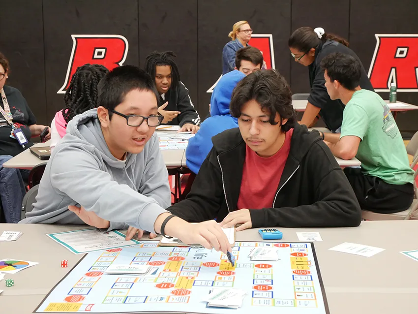 Students play an interactive game at the JA and Lit Lex event to learn about financial literacy concepts.